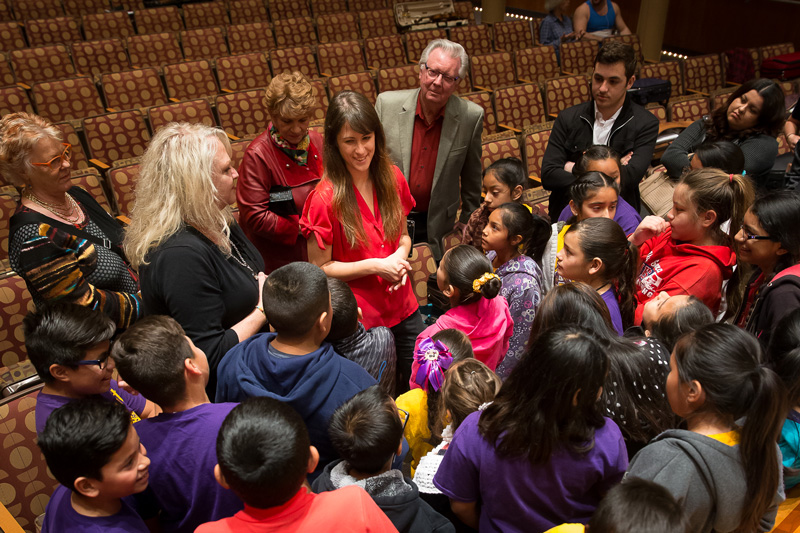 School children excitedly talking with members of the orchestra